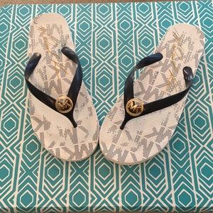 Michael Kors, thongs, with gold accent MK emblem on the top.